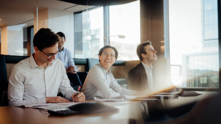 Schroders (SDR.L) interns at office conference table